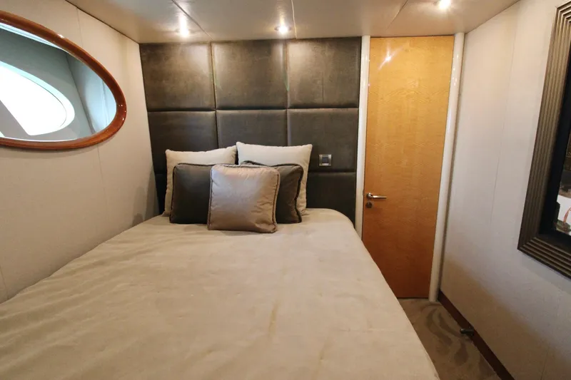 Slide: The Image of Luxurious bedroom interior of 2007 Lazzara 74 Motoryacht with plush bedding and elegant decor. - 48