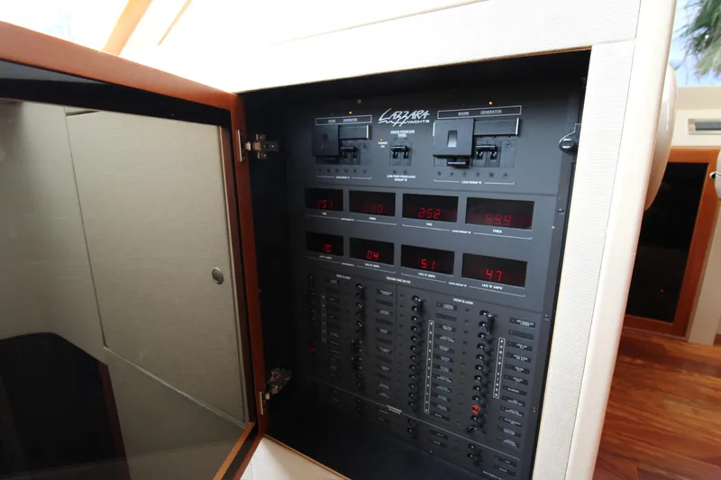 Slide: The Image of Electrical control panel inside a 2007 Lazzara 74 Motoryacht, showcasing various switches and displays. - 4