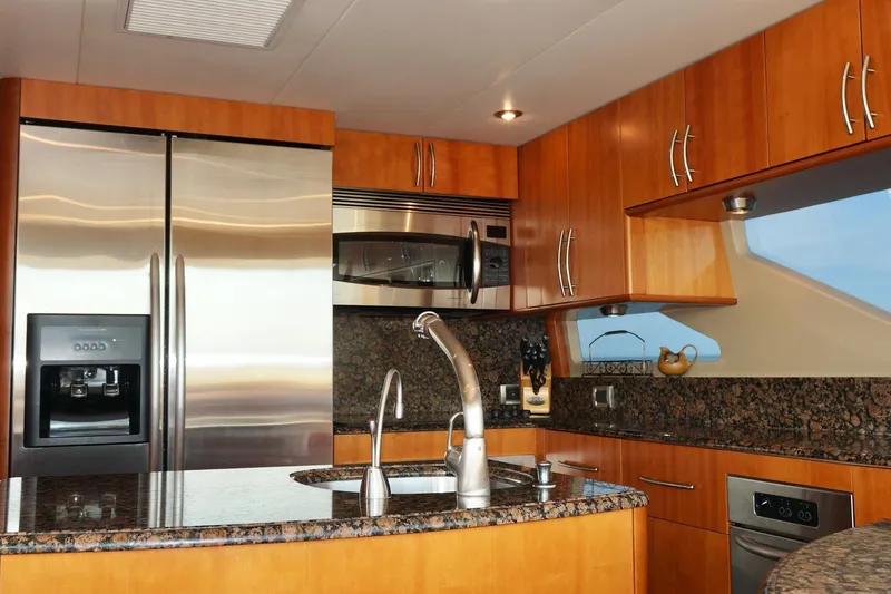 Slide: The Image of Luxurious kitchen interior of 2007 Lazzara 74 Motoryacht with modern appliances and granite countertops. - 27