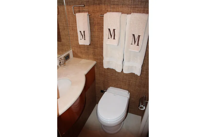 Slide: The Image of Luxurious bathroom in 2007 Lazzara 74 Motoryacht with monogrammed towels and elegant fixtures. - 52