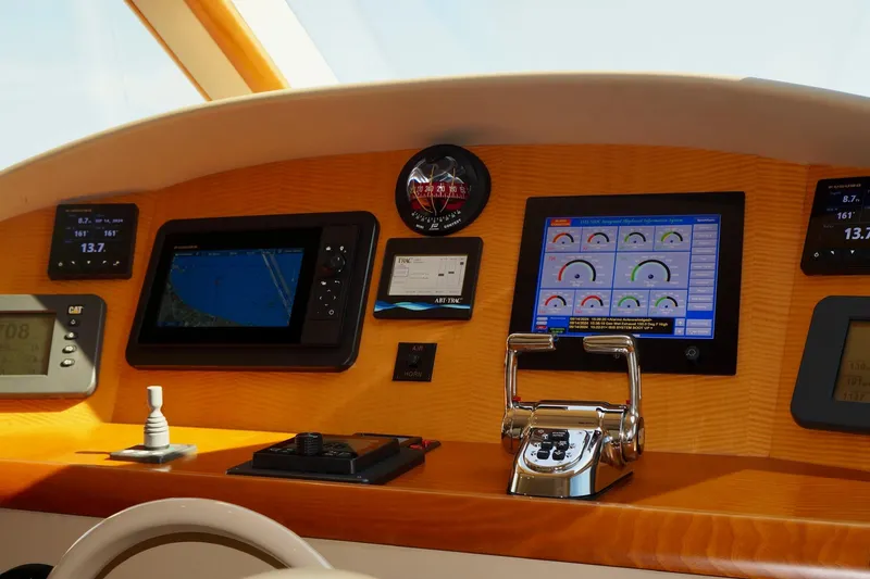 Slide: The Image of Control panel of a 2007 Lazzara 74 Motoryacht with navigation and monitoring screens. - 6