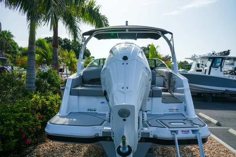 Slide: The Image of 2027 Four Winns HD8 OB boat with outboard motor, parked near palm trees. - 5