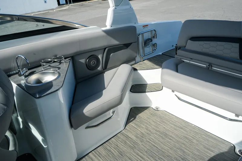 Slide: The Image of 2027 Four Winns HD8 OB boat interior with seating, sink, and modern design features. - 33