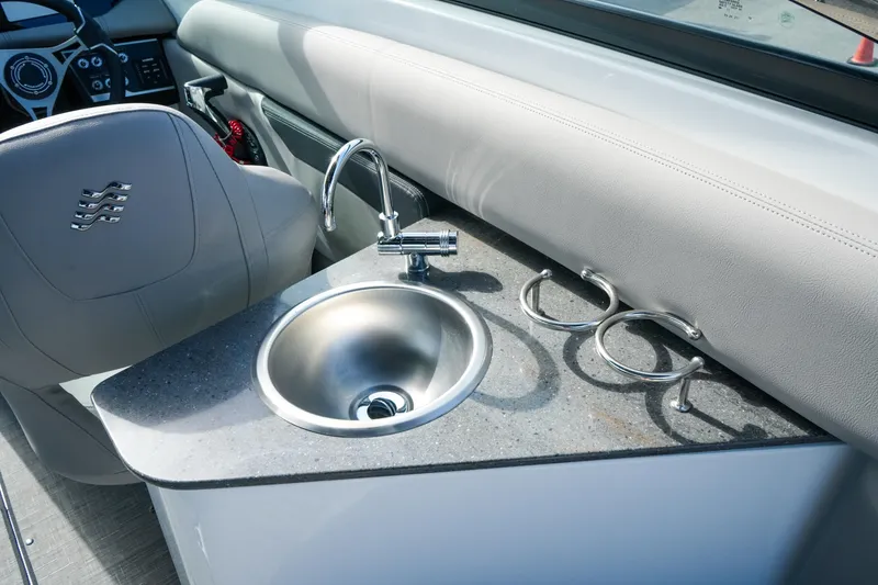 Slide: The Image of 2027 Four Winns HD8 OB boat interior with sink and cup holders. - 13