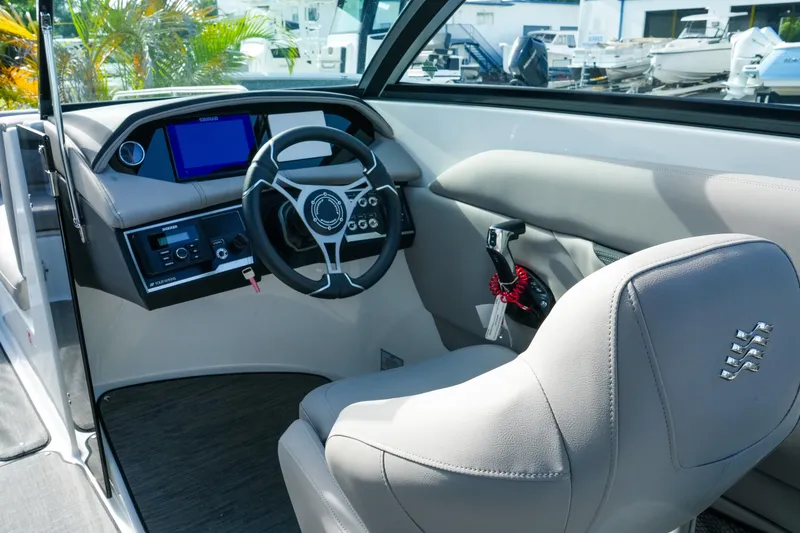 Slide: The Image of 2027 Four Winns HD8 OB boat cockpit with modern steering and control panel. - 15