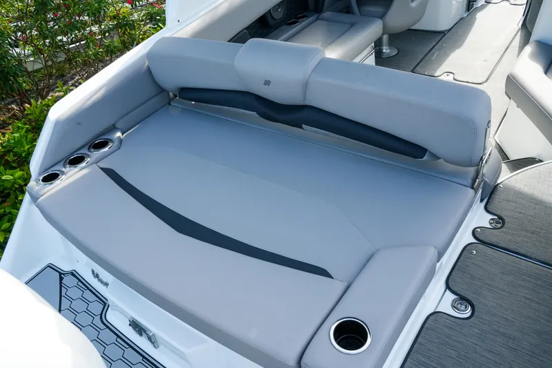 Slide: The Image of 2027 Four Winns HD8 OB boat interior with gray seating and cup holders. - 8