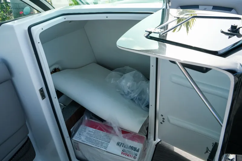 Slide: The Image of Storage compartment in 2027 Four Winns HD8 OB boat, featuring Yamaha accessories. - 21