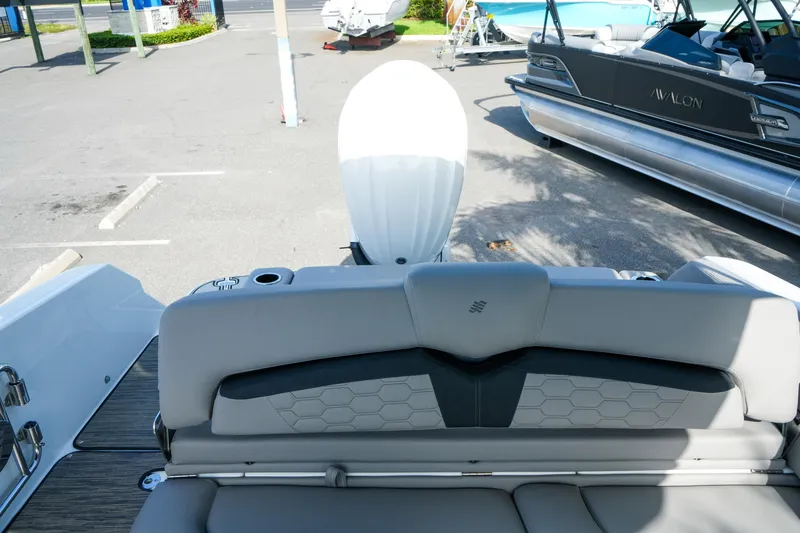 Slide: The Image of 2027 Four Winns HD8 OB boat interior with outboard motor in parking lot. - 35
