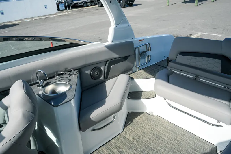 Slide: The Image of 2027 Four Winns HD8 OB boat interior with seating, sink, and cup holders. - 34