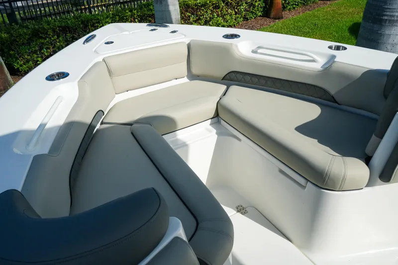 Slide: The Image of 2027 Key West 249 FS boat interior with cushioned seating and cup holders. - 44
