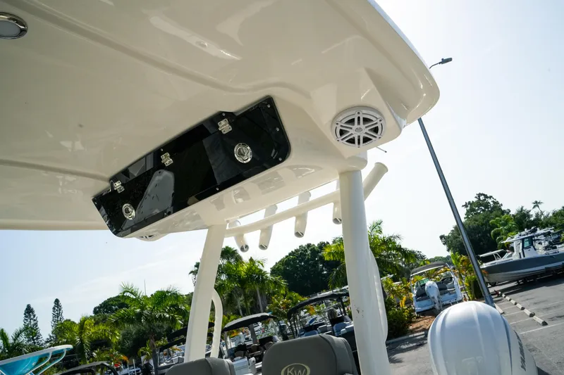 Slide: The Image of 2027 Key West 249 FS boat with T-top and speaker, parked outdoors. - 46
