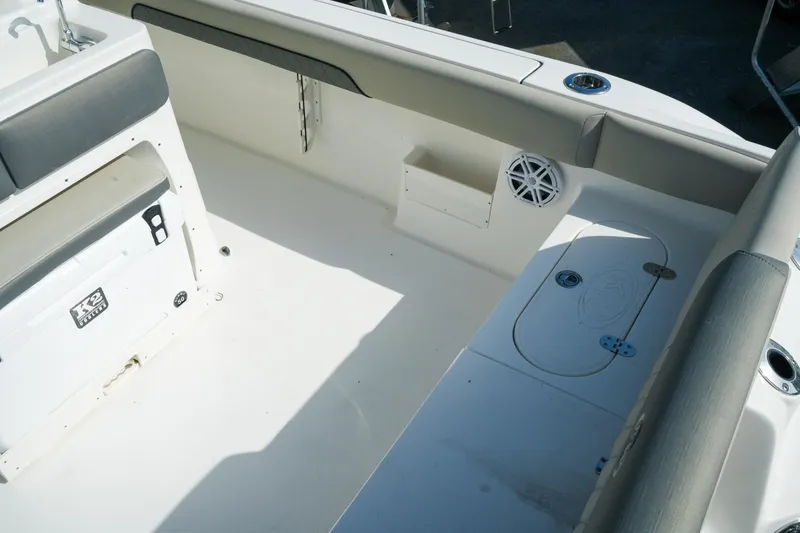 Slide: The Image of 2027 Key West 249 FS boat interior with seating, storage, and speaker. - 19