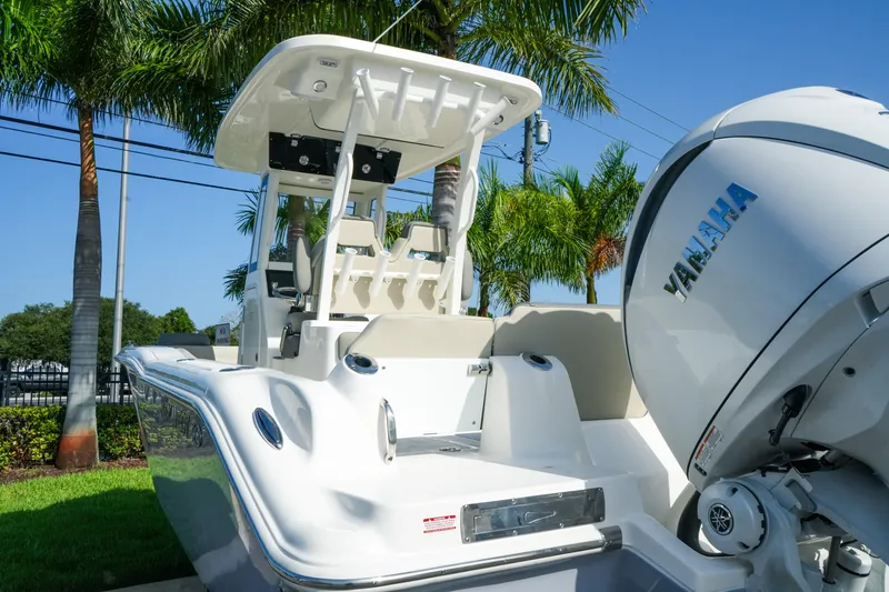 Slide: The Image of 2027 Key West 249 FS boat with Yamaha engine, parked near palm trees. - 13