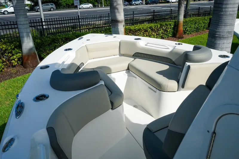 Slide: The Image of 2027 Key West 249 FS boat interior with cushioned seating and cup holders. - 43