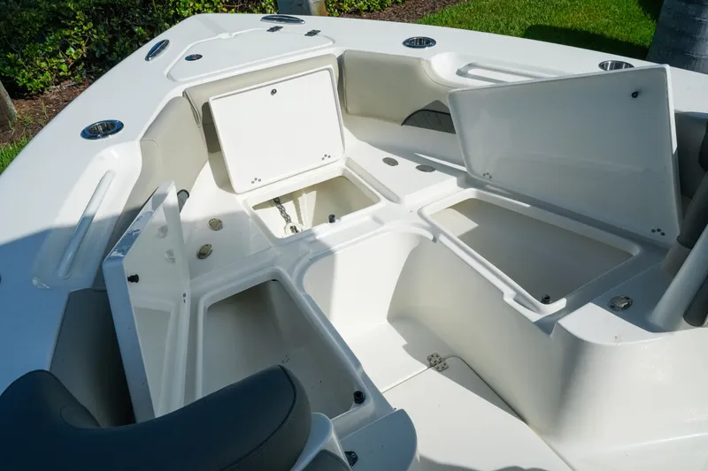 Slide: The Image of 2027 Key West 249 FS boat with open storage compartments on deck. - 31