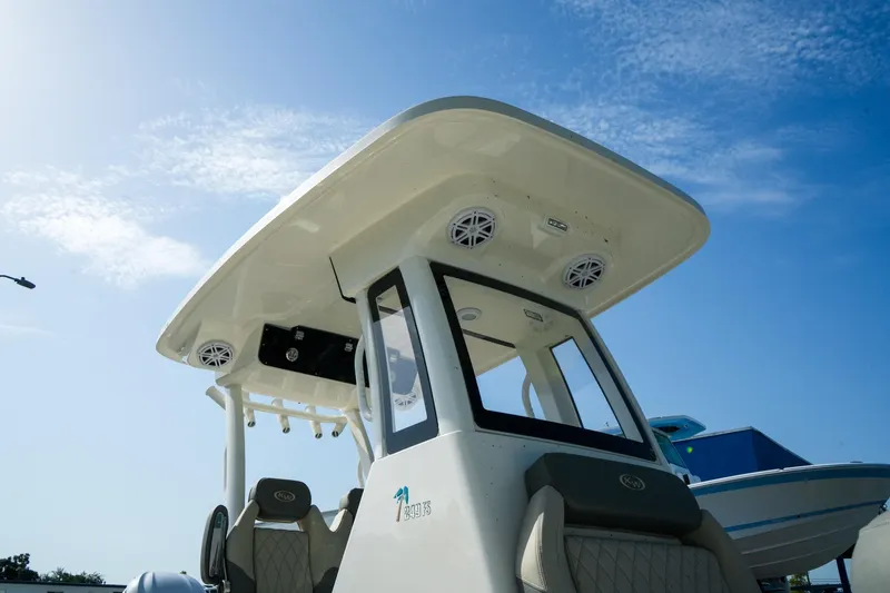 Slide: The Image of 2027 Key West 249 FS boat with T-top and speakers under a clear blue sky. - 7