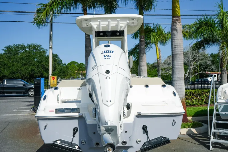 Slide: The Image of 2027 Key West 249 FS boat with powerful 300 V6 engine, parked outdoors. - 10