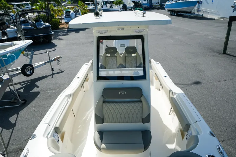 Slide: The Image of 2027 Key West 249 FS boat with sleek seating and modern design in a marina setting. - 35