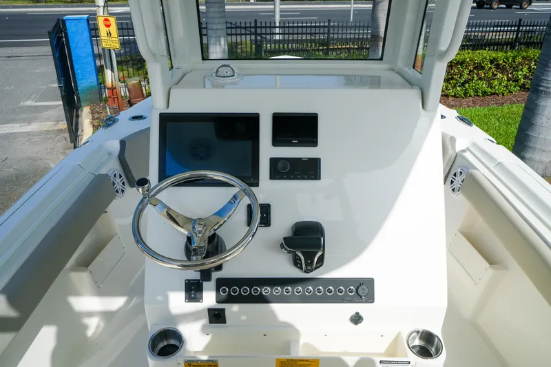 Slide: The Image of 2027 Key West 249 FS boat dashboard with steering wheel and control panel. - 22