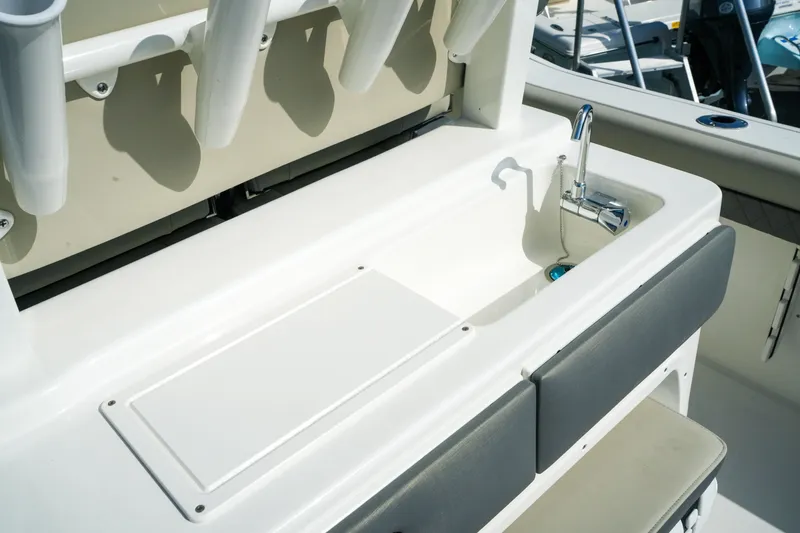 Slide: The Image of 2027 Key West 249 FS boat sink and storage area with rod holders. - 21