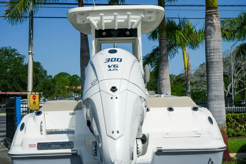 Slide: The Image of Key West 249 FS 2027 boat with powerful 300 V6 engine, parked near palm trees. - 11