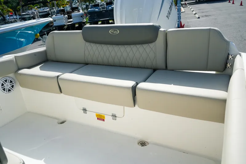Slide: The Image of 2027 Key West 249 FS boat seating area with gray and beige upholstery. - 48