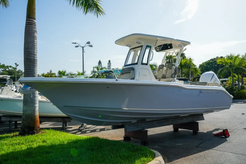Slide: The Image of 2027 Key West 249 FS boat displayed outdoors with palm trees. - 3