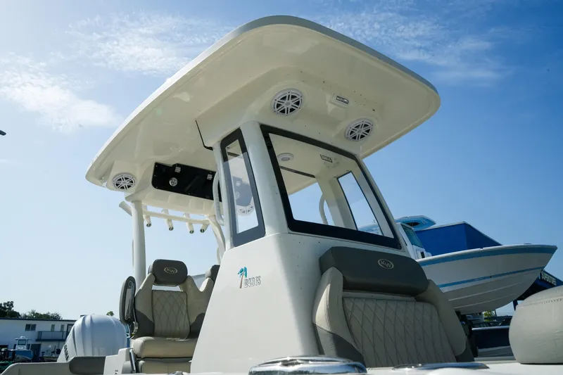 Slide: The Image of 2027 Key West 249 FS boat with modern seating and canopy under a clear blue sky. - 8