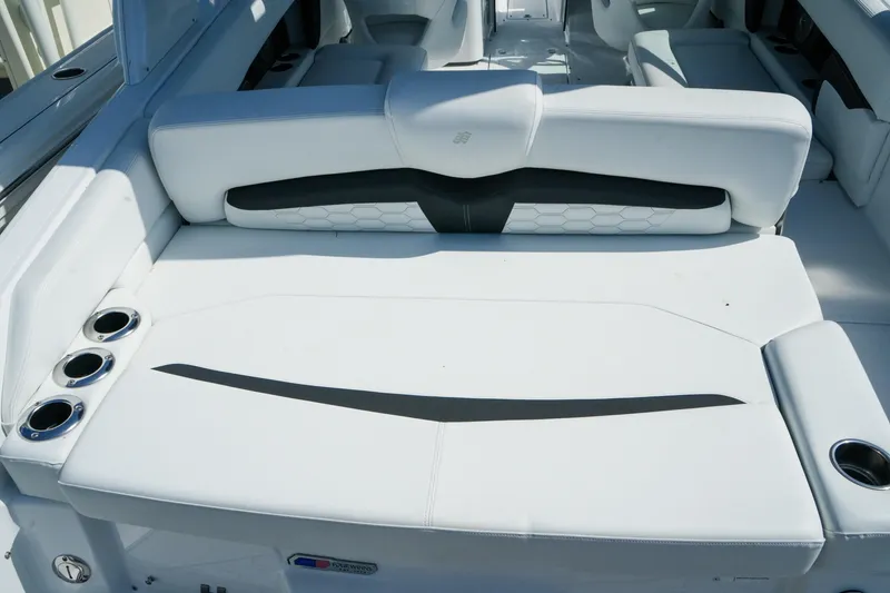 Slide: The Image of 2026 Four Winns HD8 OB boat interior with white seating and cup holders. - 8