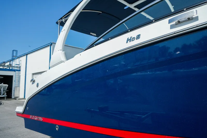 Slide: The Image of 2026 Four Winns HD8 OB boat with sleek blue and white design. - 5