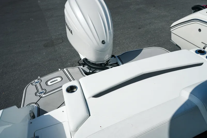 Slide: The Image of 2026 Four Winns HD8 OB boat with Yamaha outboard motor, featuring sleek white seating. - 27