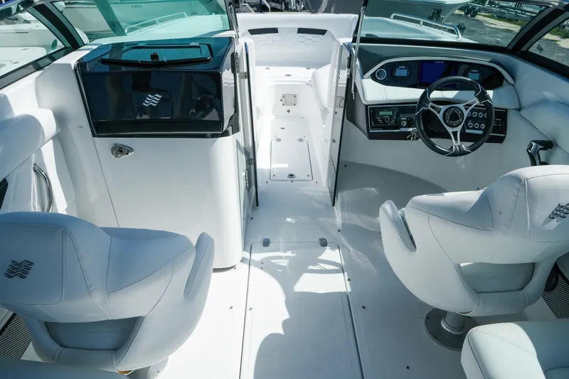 Slide: The Image of Interior of 2026 Four Winns HD8 OB boat with modern helm and seating. - 12