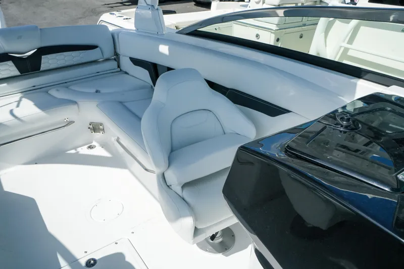 Slide: The Image of 2026 Four Winns HD8 OB boat interior with sleek white seating and modern dashboard design. - 22
