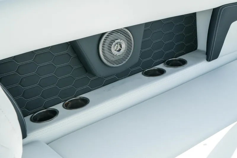 Slide: The Image of 2026 Four Winns HD8 OB boat interior with speaker and cup holders. - 24