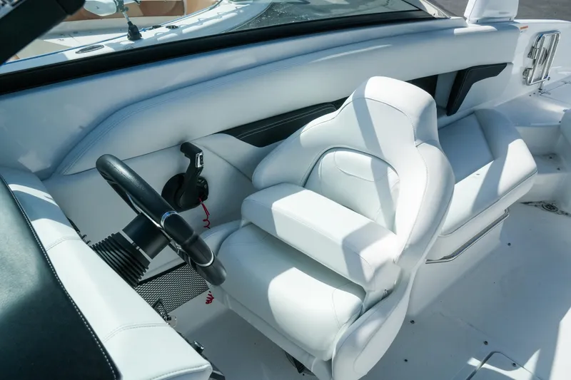 Slide: The Image of 2026 Four Winns HD8 OB boat interior with white captain's seat and steering wheel. - 21