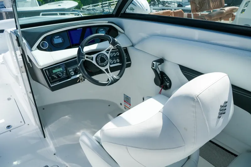 Slide: The Image of Interior view of 2026 Four Winns HD8 OB boat cockpit with modern controls and white seating. - 13