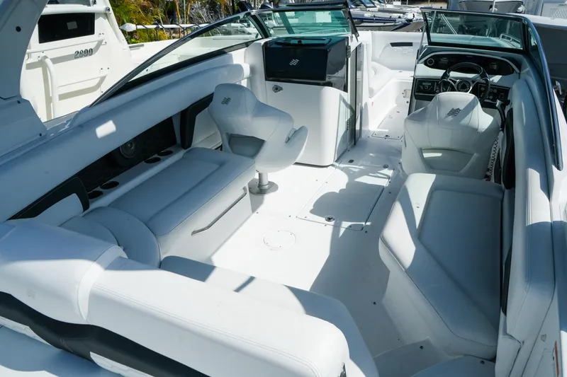 Slide: The Image of 2026 Four Winns HD8 OB boat interior with white seating and modern dashboard. - 10