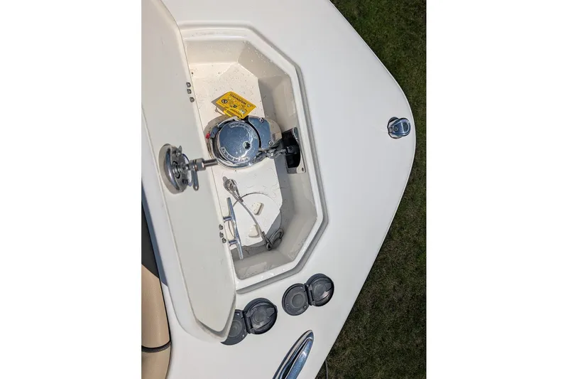 Slide: The Image of 2020 NauticStar 2602 Legacy boat anchor compartment with winch and controls. - 31
