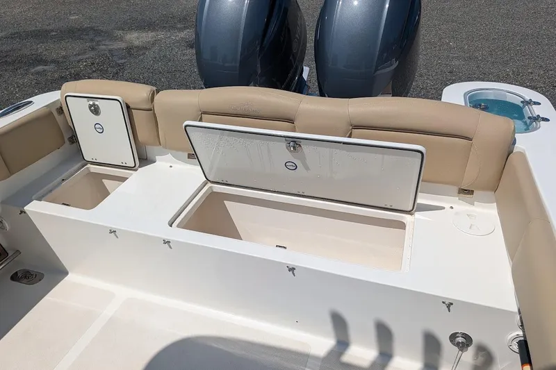 Slide: The Image of 2020 NauticStar 2602 Legacy boat with open storage compartments and dual engines. - 4