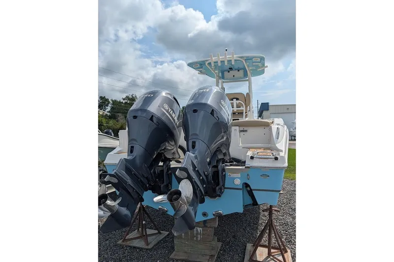 Slide: The Image of 2020 NauticStar 2602 Legacy boat with dual Yamaha outboard engines, displayed outdoors. - 1