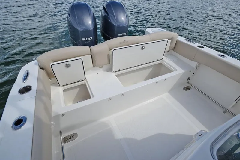 Slide: The Image of Manufacturer Provided Image: 2020 NauticStar 2602 Legacy boat with twin 200 HP engines, spacious deck, and storage compartments. - 30