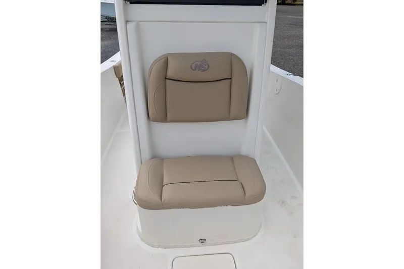 Slide: The Image of 2020 NauticStar 2602 Legacy boat seat with beige cushions and logo. - 12