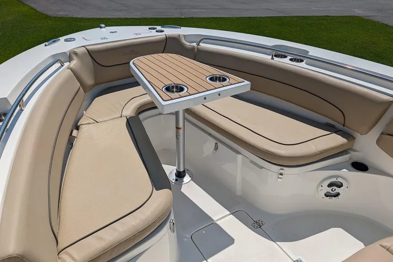 Slide: The Image of 2020 NauticStar 2602 Legacy boat interior with cushioned seating and table. - 23