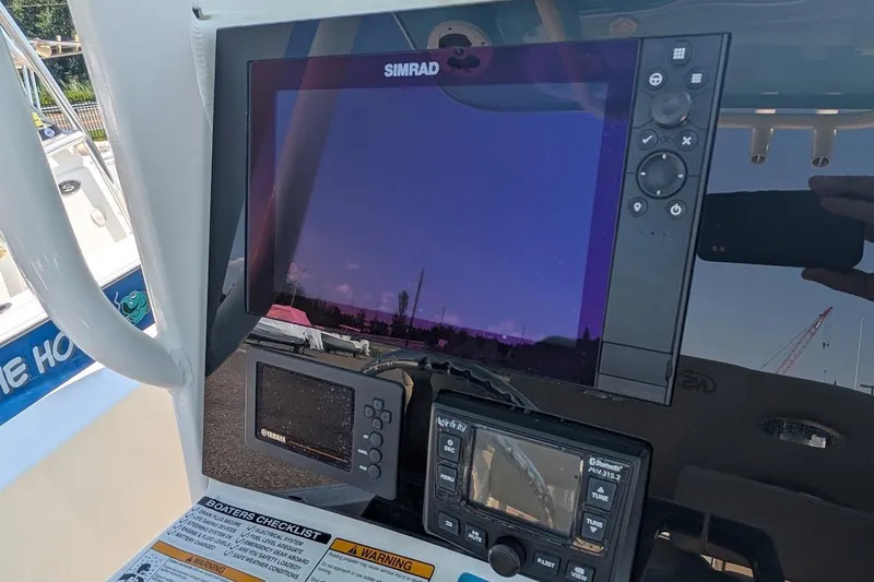 Slide: The Image of Simrad display on 2020 NauticStar 2602 Legacy boat dashboard with control panel. - 11