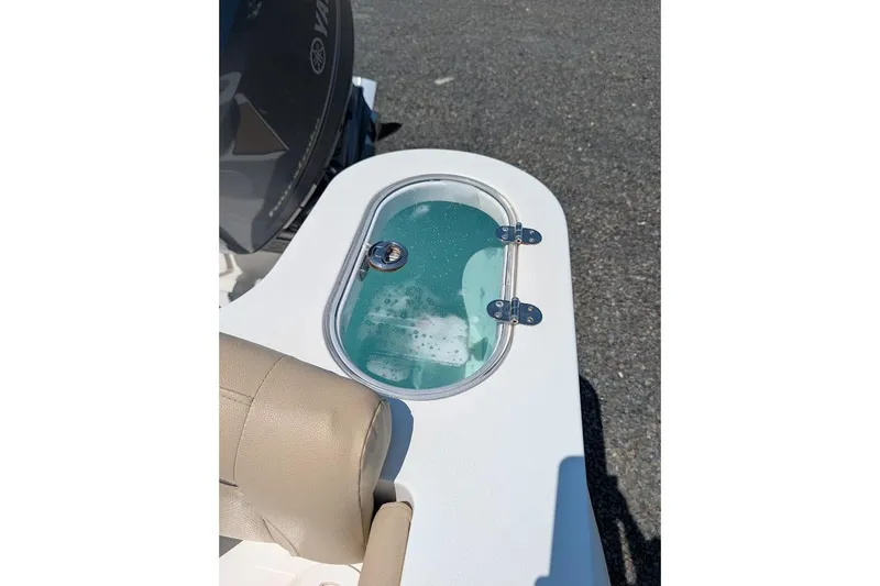 Slide: The Image of 2020 NauticStar 2602 Legacy boat livewell with clear lid and water inside. - 6
