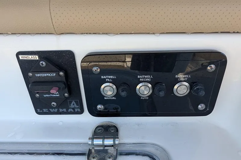 Slide: The Image of Control panel of a 2020 NauticStar 2602 Legacy boat with baitwell and windlass switches. - 9