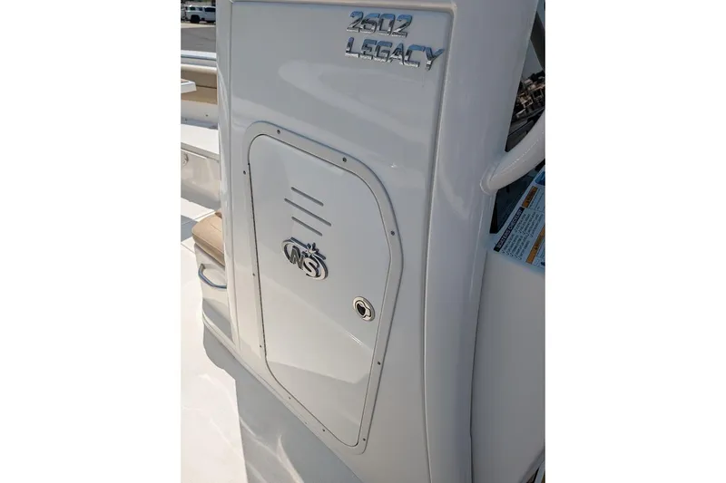 Slide: The Image of 2020 NauticStar 2602 Legacy boat interior detail with logo and storage compartment. - 18