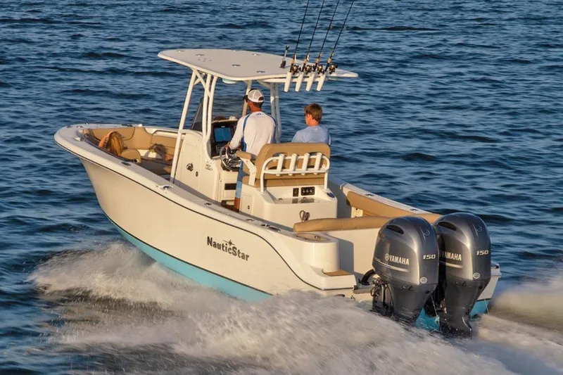 Slide: The Image of Manufacturer Provided Image: 2020 NauticStar 2602 Legacy boat cruising on water with dual Yamaha engines. - 20