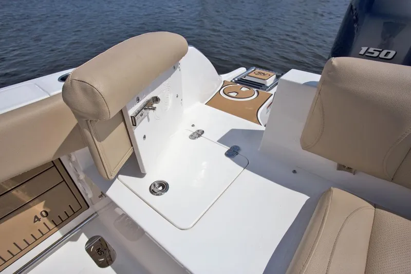 Slide: The Image of Manufacturer Provided Image: 2020 NauticStar 2602 Legacy boat interior with beige seating and fishing equipment. - 32