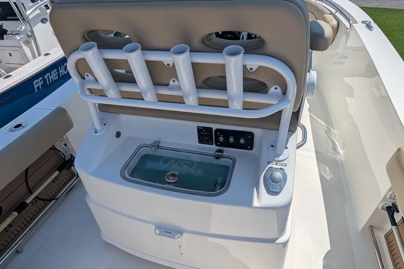 Slide: The Image of 2020 NauticStar 2602 Legacy boat interior with rod holders and control panel. - 7